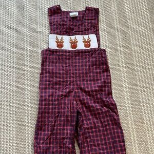 Smocked reindeer coverall. Buttons up legs and top.